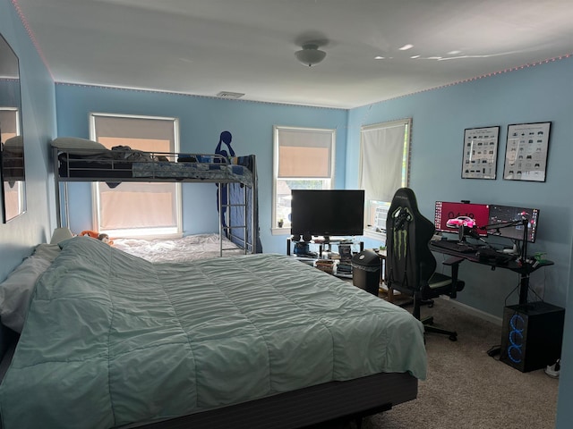 carpeted bedroom with visible vents and baseboards