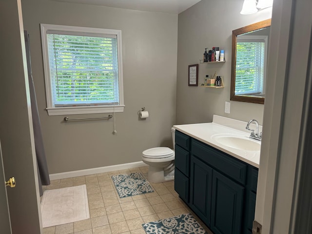 full bath with baseboards, vanity, toilet, and tile patterned floors