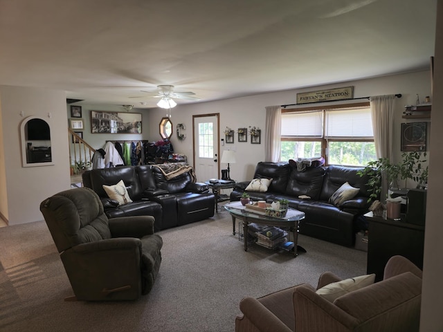 living room featuring carpet floors and a ceiling fan