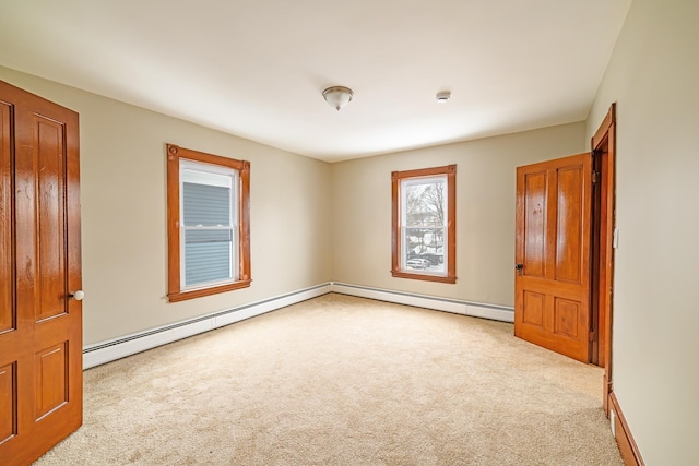 unfurnished room with carpet floors and baseboard heating