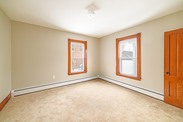 carpeted empty room featuring baseboard heating