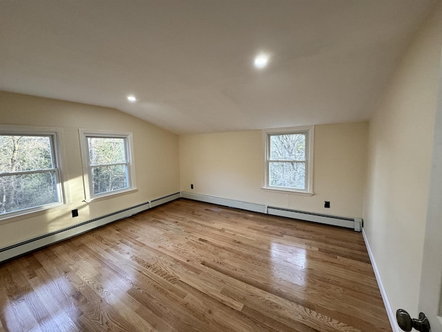 bonus room with plenty of natural light, baseboards, vaulted ceiling, and wood finished floors