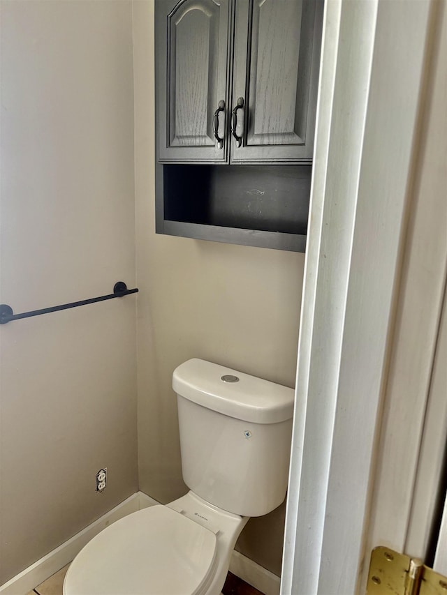 bathroom featuring toilet and baseboards