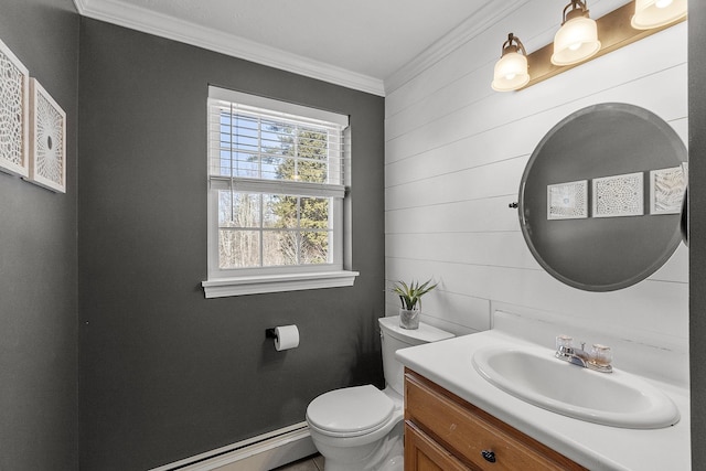 half bath with ornamental molding, baseboard heating, vanity, and toilet