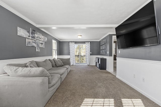 carpeted living area featuring crown molding and baseboards