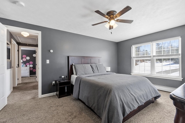 carpeted bedroom with attic access, baseboards, baseboard heating, and a ceiling fan