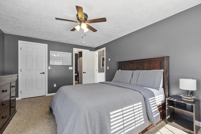 bedroom with ceiling fan, carpet, and baseboards