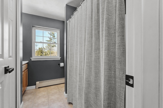 full bath featuring a baseboard radiator, tile patterned flooring, vanity, and baseboards