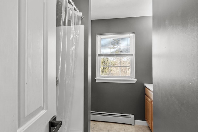 bathroom with tile patterned flooring, a baseboard heating unit, vanity, baseboards, and a shower with curtain