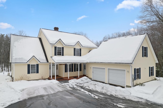 view of front of house featuring a chimney and an attached garage