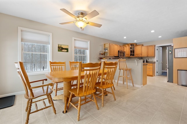 dining area with a ceiling fan, recessed lighting, baseboards, and light tile patterned floors