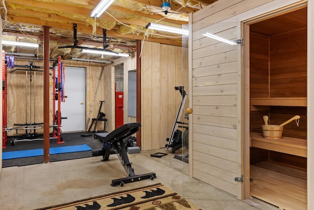 workout room with wood walls and a sauna