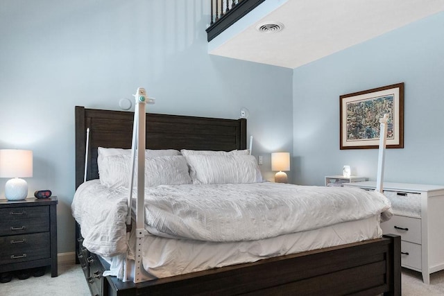 bedroom featuring light colored carpet and visible vents