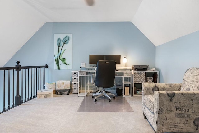 carpeted home office with lofted ceiling