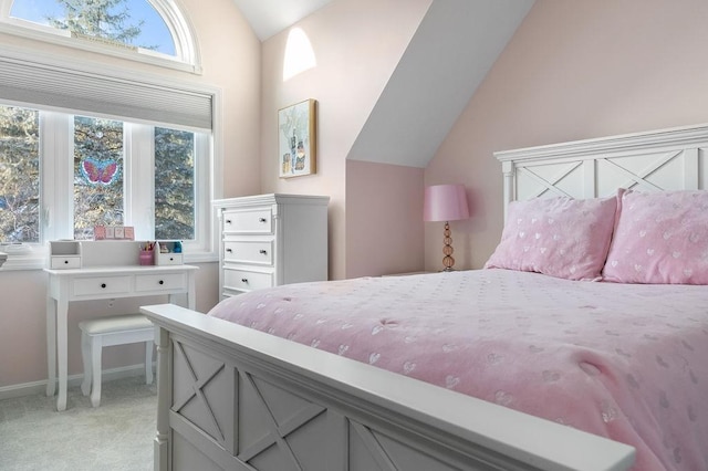 bedroom featuring lofted ceiling and light carpet