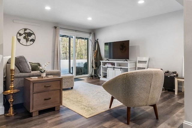 living area with dark wood-type flooring and recessed lighting