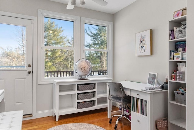 office area featuring ceiling fan, baseboards, and wood finished floors