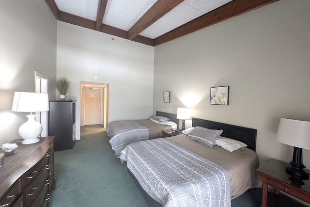 bedroom with beam ceiling, dark carpet, and a towering ceiling