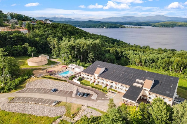 bird's eye view featuring a wooded view and a water and mountain view