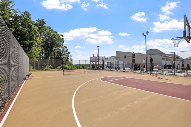 view of basketball court featuring community basketball court and fence