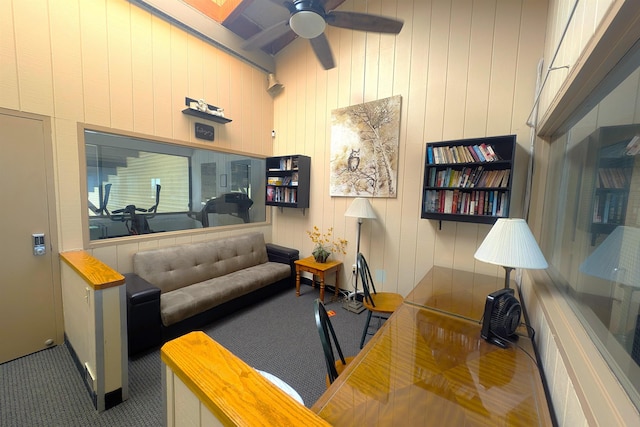 carpeted office with a ceiling fan