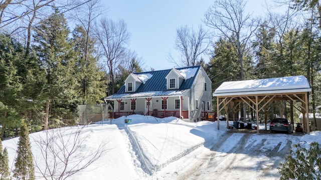 view of front of home with a carport, a standing seam roof, and metal roof