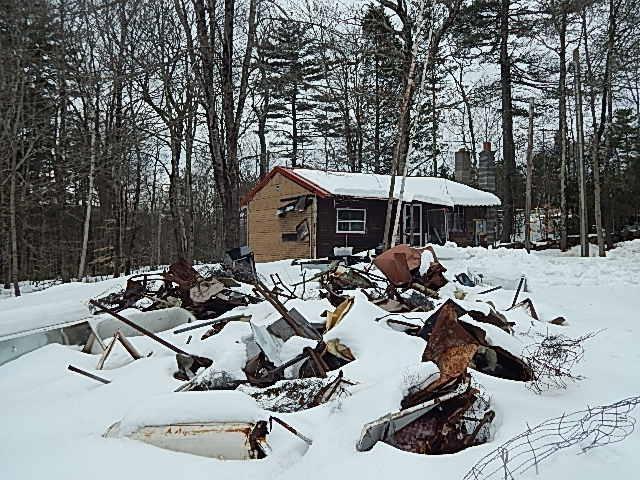 snowy yard with a garage