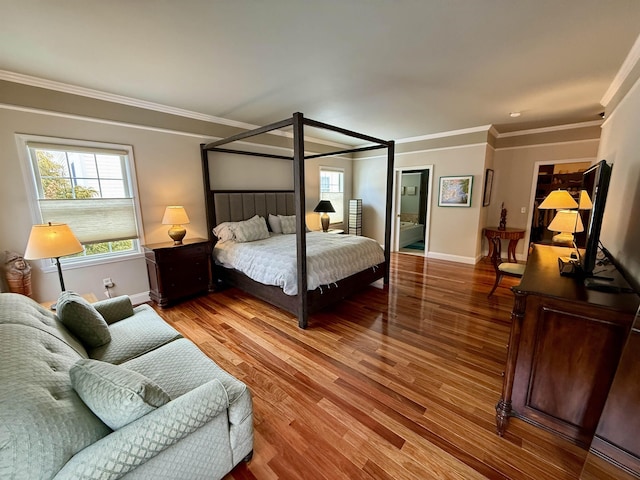 bedroom with baseboards, ornamental molding, and wood finished floors