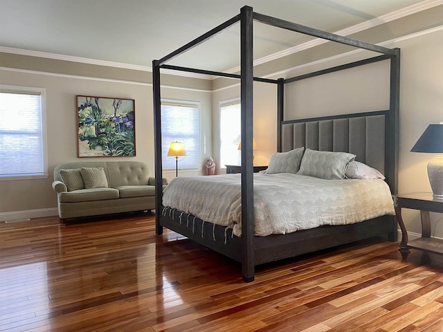 bedroom with wood-type flooring, multiple windows, and crown molding