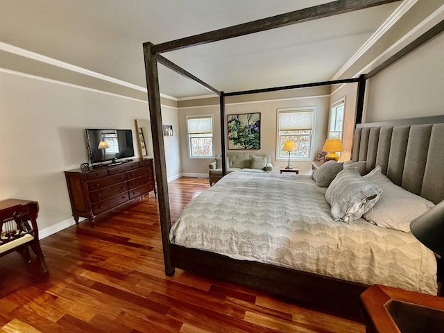 bedroom featuring crown molding, baseboards, and wood finished floors