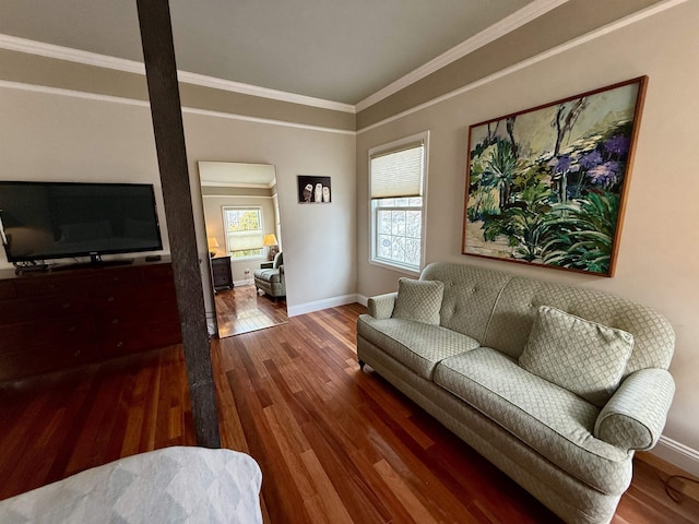 living area featuring a wealth of natural light, crown molding, baseboards, and wood finished floors