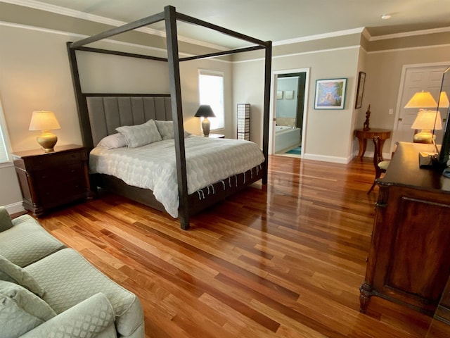 bedroom with crown molding, baseboards, and wood finished floors