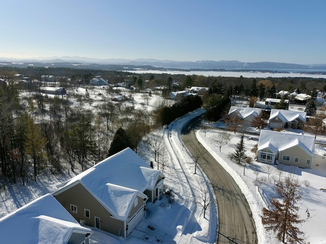 snowy aerial view with a mountain view