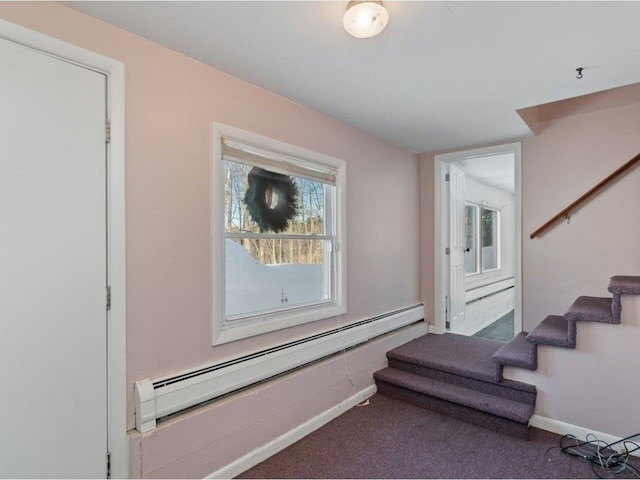 stairway with baseboard heating, carpet, a wealth of natural light, and baseboards