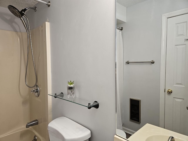 bathroom with toilet, a sink, and shower / bathtub combination