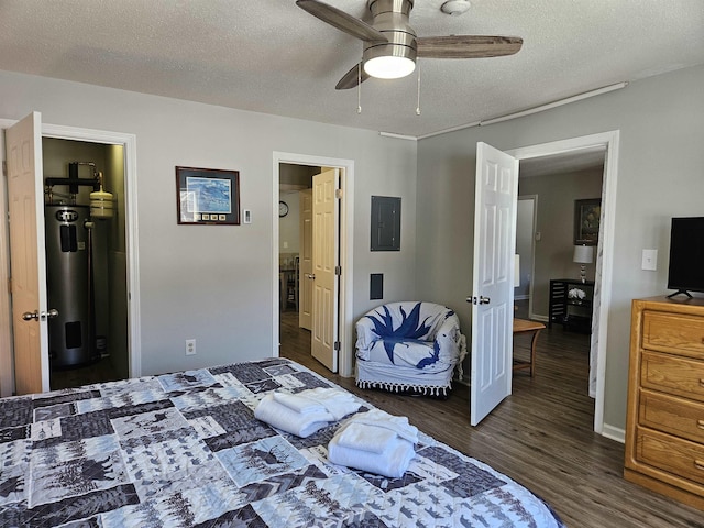 bedroom featuring electric panel, a textured ceiling, water heater, and wood finished floors