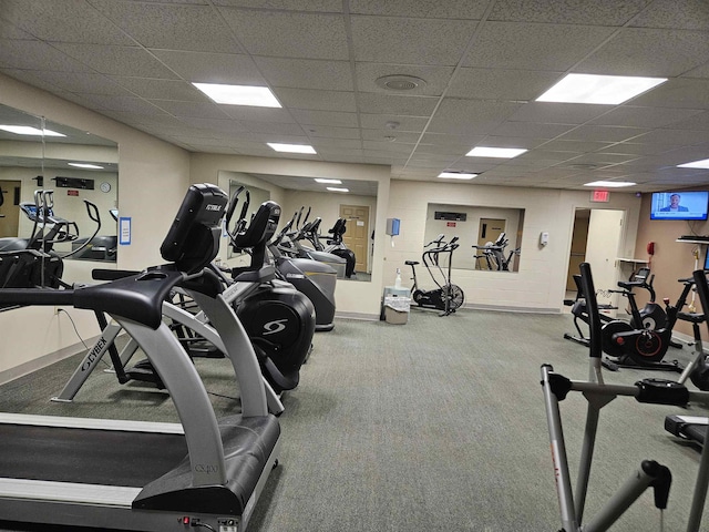 exercise room featuring carpet floors and a drop ceiling