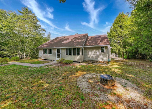 rear view of property with a yard