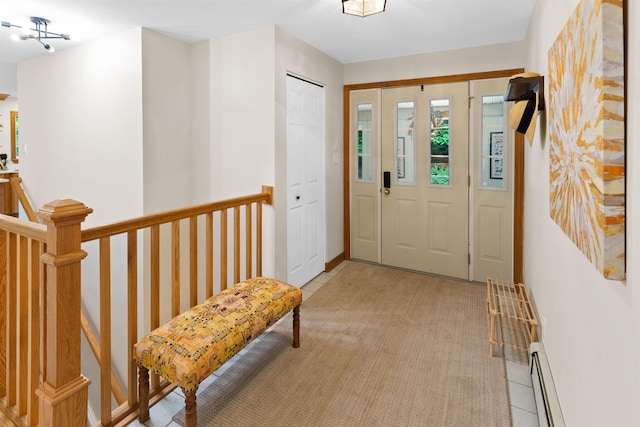 entrance foyer featuring light colored carpet and baseboard heating