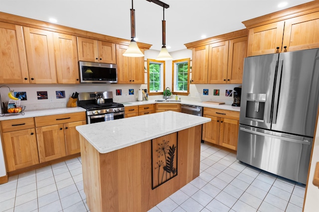 kitchen with light stone counters, a center island, decorative light fixtures, light tile patterned floors, and stainless steel appliances