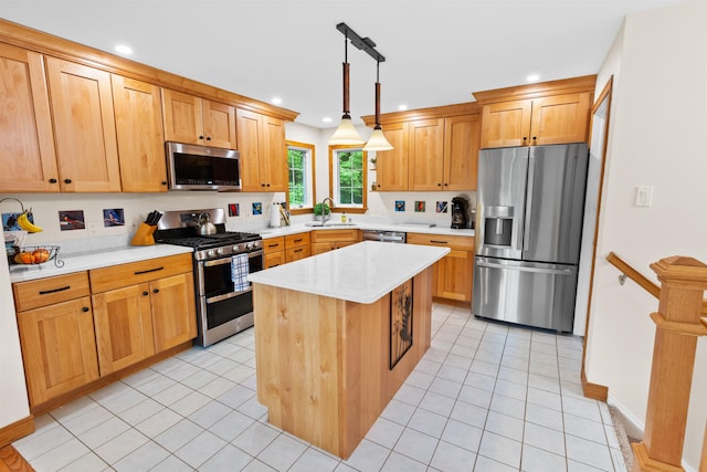 kitchen featuring light tile patterned flooring, stainless steel appliances, a kitchen island, a sink, and hanging light fixtures