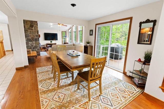 dining room featuring light wood-style flooring, a baseboard heating unit, and a ceiling fan