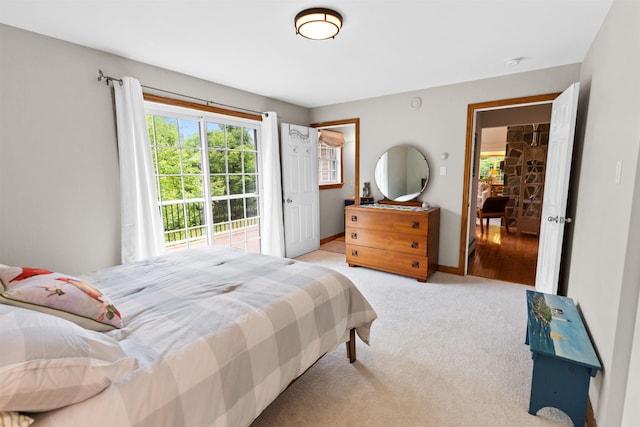 bedroom featuring light colored carpet and baseboards