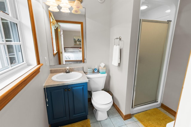 bathroom with baseboards, toilet, tile patterned floors, vanity, and a shower stall