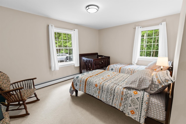 carpeted bedroom with a baseboard radiator