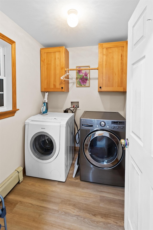 laundry room with light wood-type flooring, cabinet space, independent washer and dryer, and baseboard heating