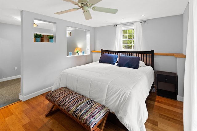 bedroom featuring a ceiling fan, recessed lighting, baseboards, and wood finished floors