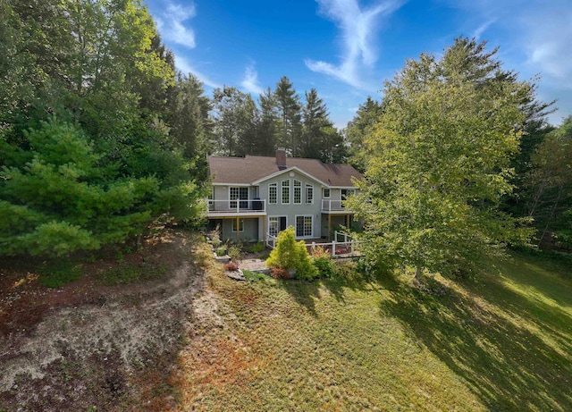 view of front of house with a front yard and a chimney