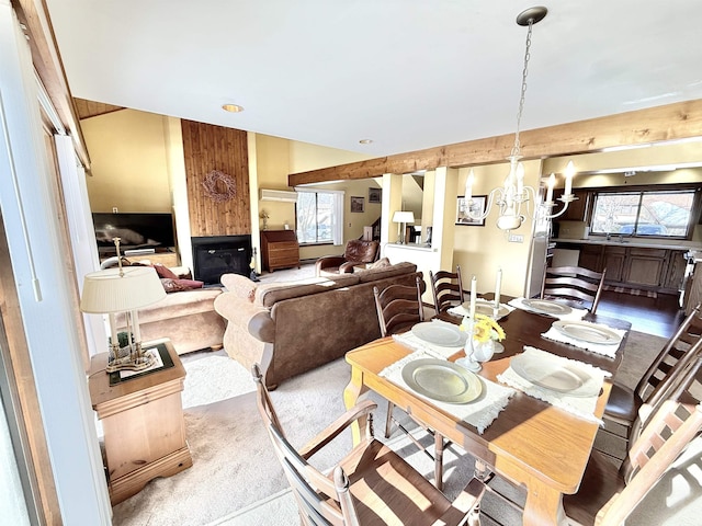 carpeted dining space featuring a wealth of natural light and an inviting chandelier