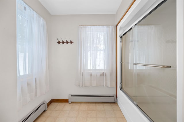 full bath with a baseboard heating unit, bath / shower combo with glass door, baseboards, and tile patterned floors